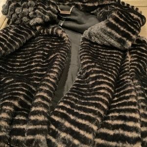 Long dressy faux fur vest with a hood